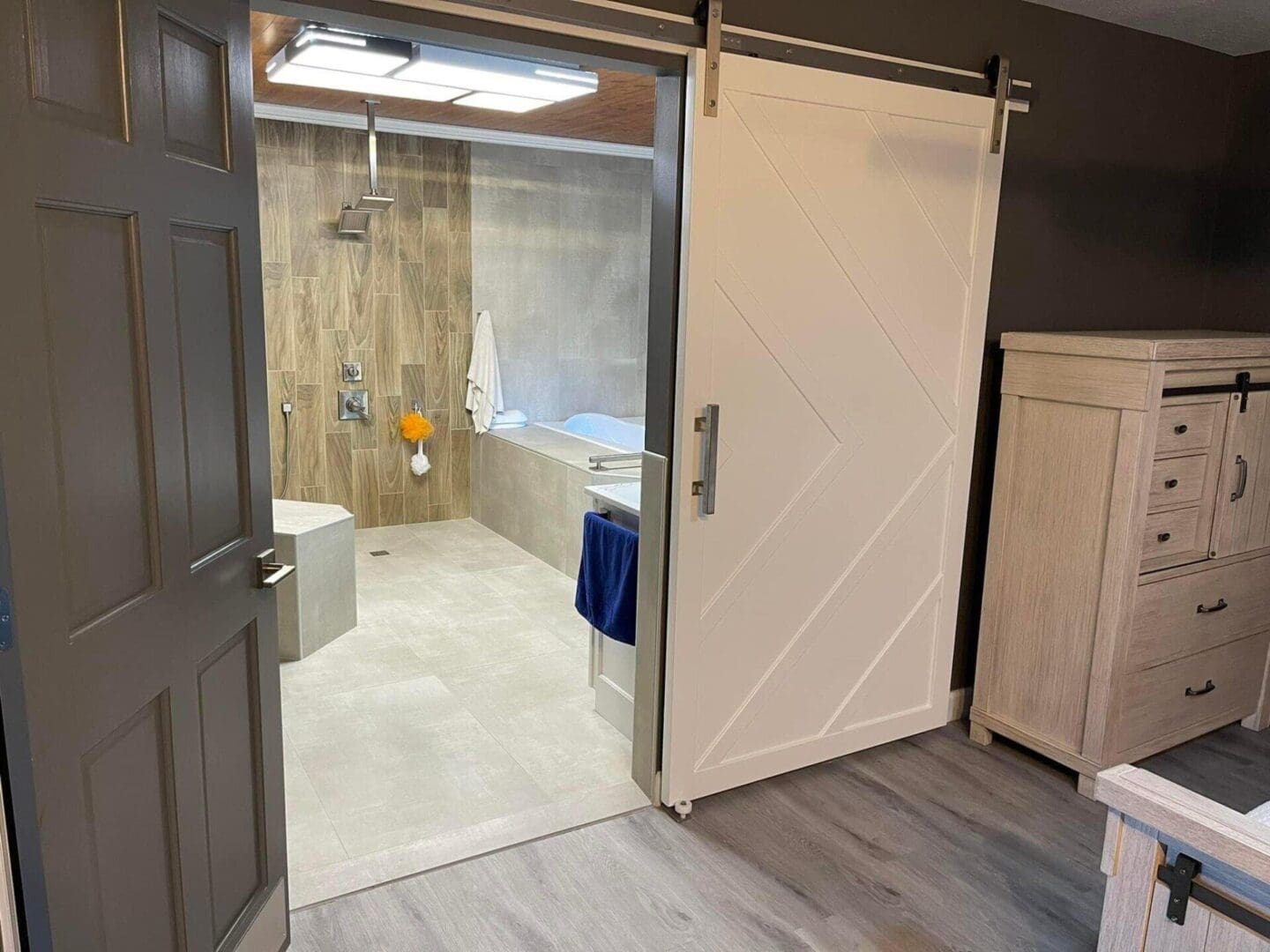 A bathroom with a tub and shower next to the door.