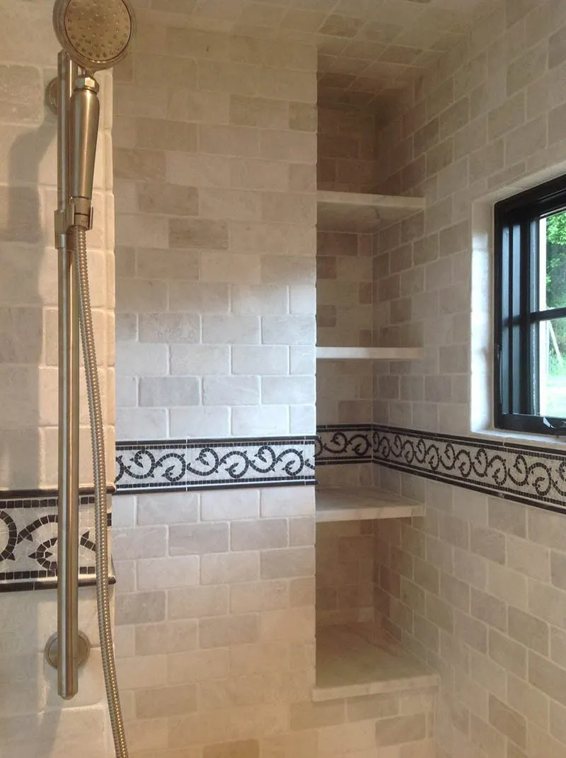 A bathroom with tiled walls and floors