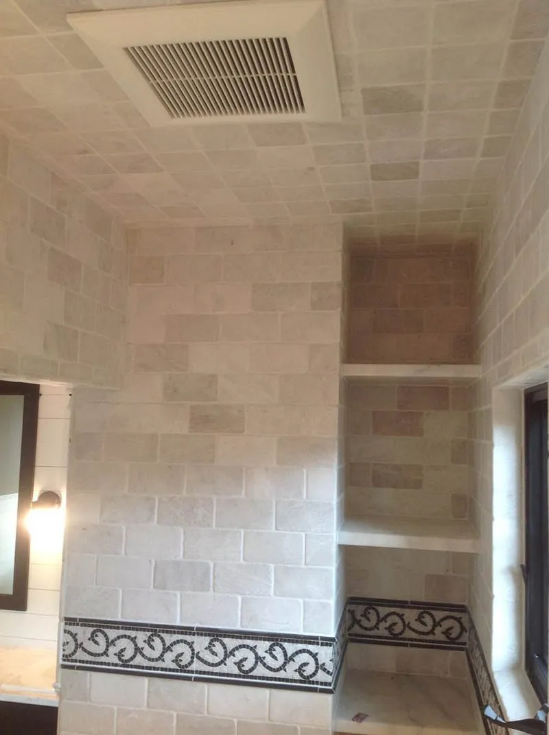 A room with a tiled ceiling and walls.