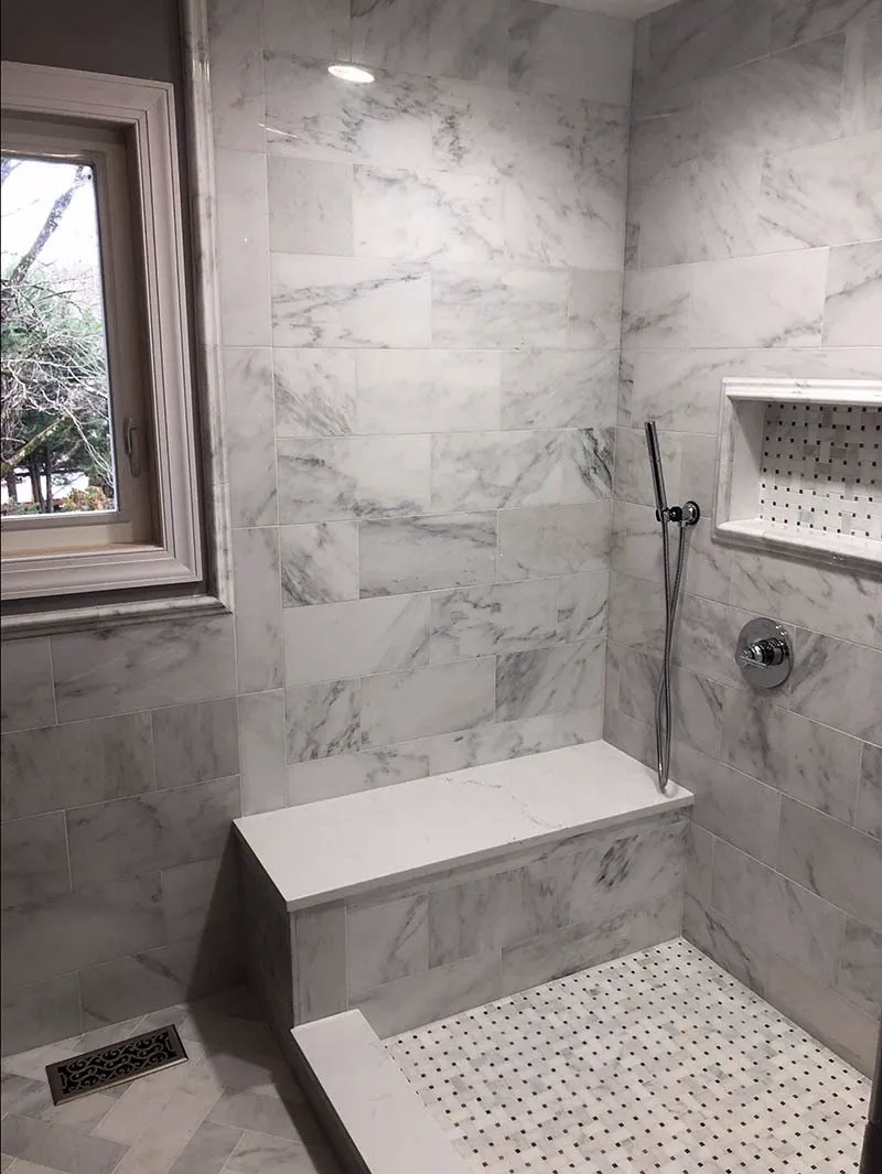 A bathroom with marble walls and floor