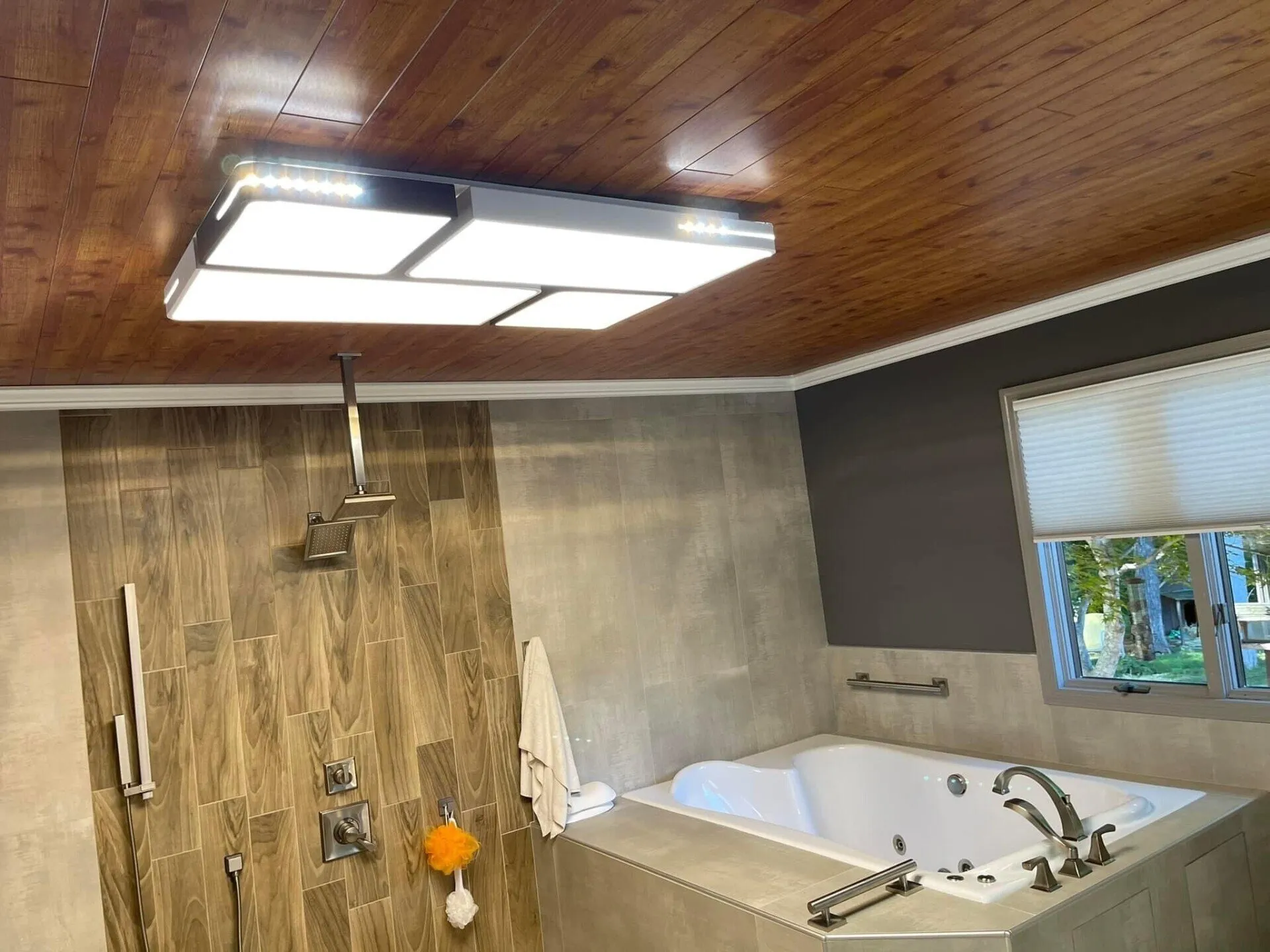 A bathroom with a tub, shower and tiled walls.