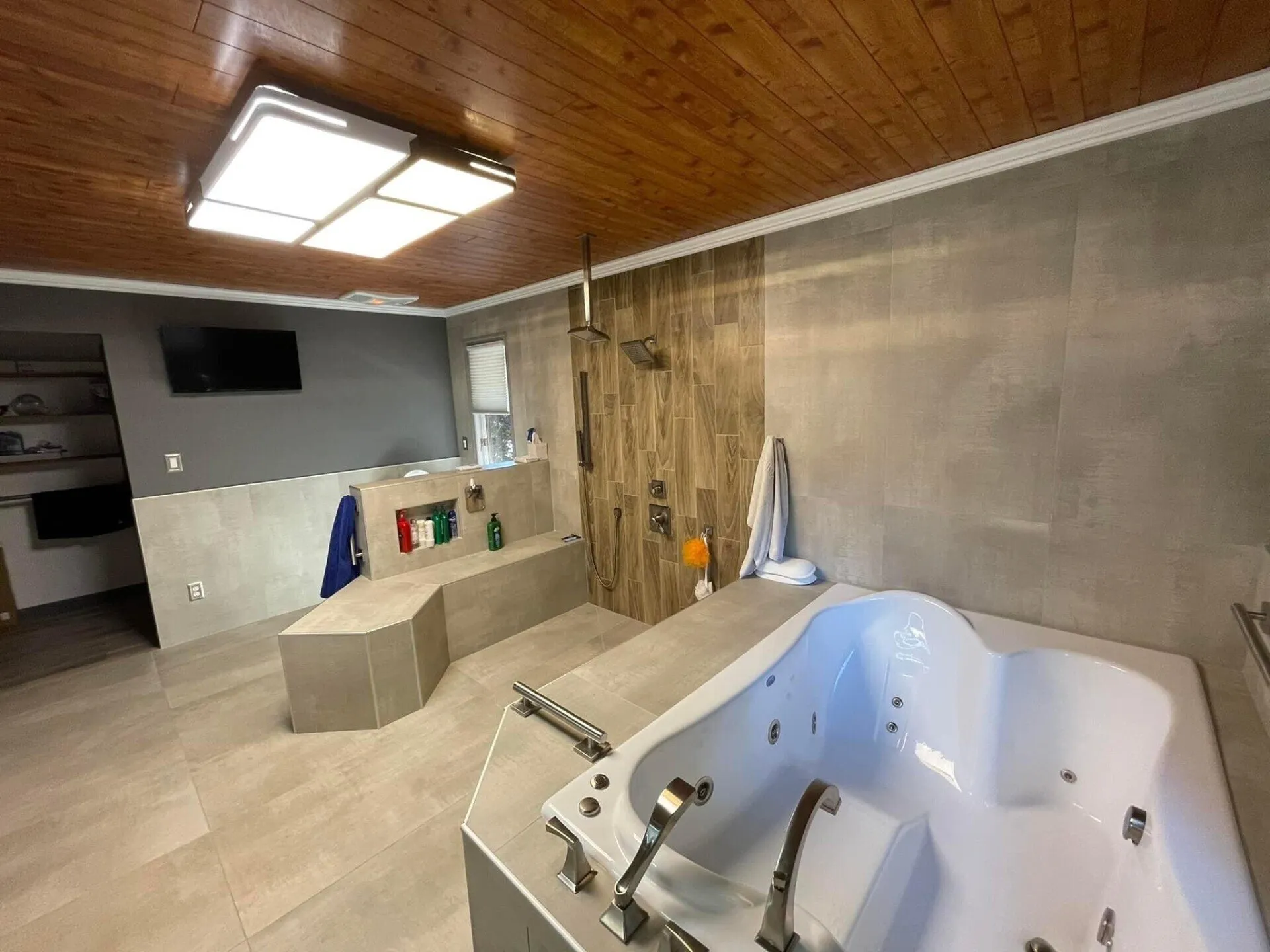 A large bathroom with a tub and shower.