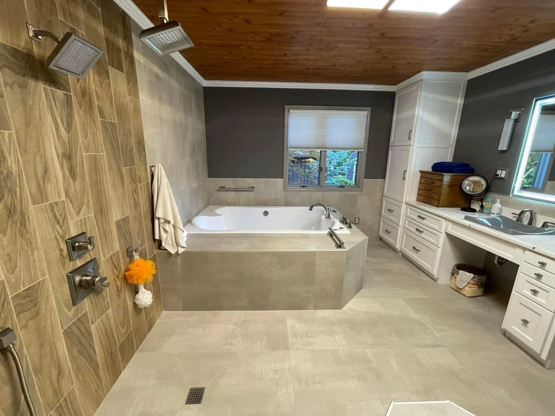 A bathroom with a tub, sink and shower.