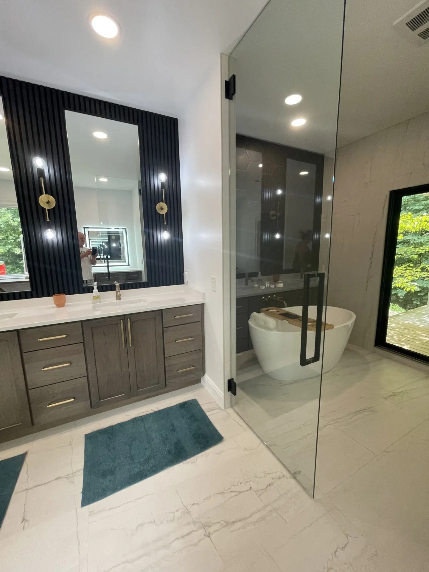 A bathroom with a large mirror and a sink.